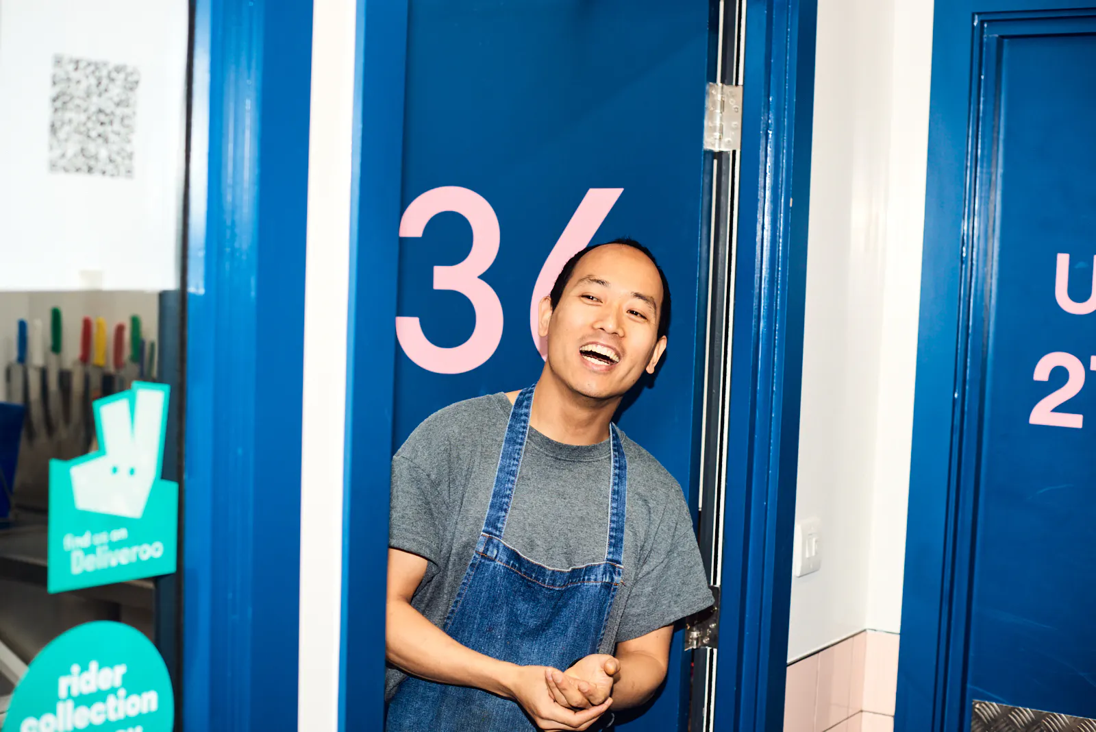 Chef popping his head out of his kitchen at Karma Kitchen Hackney