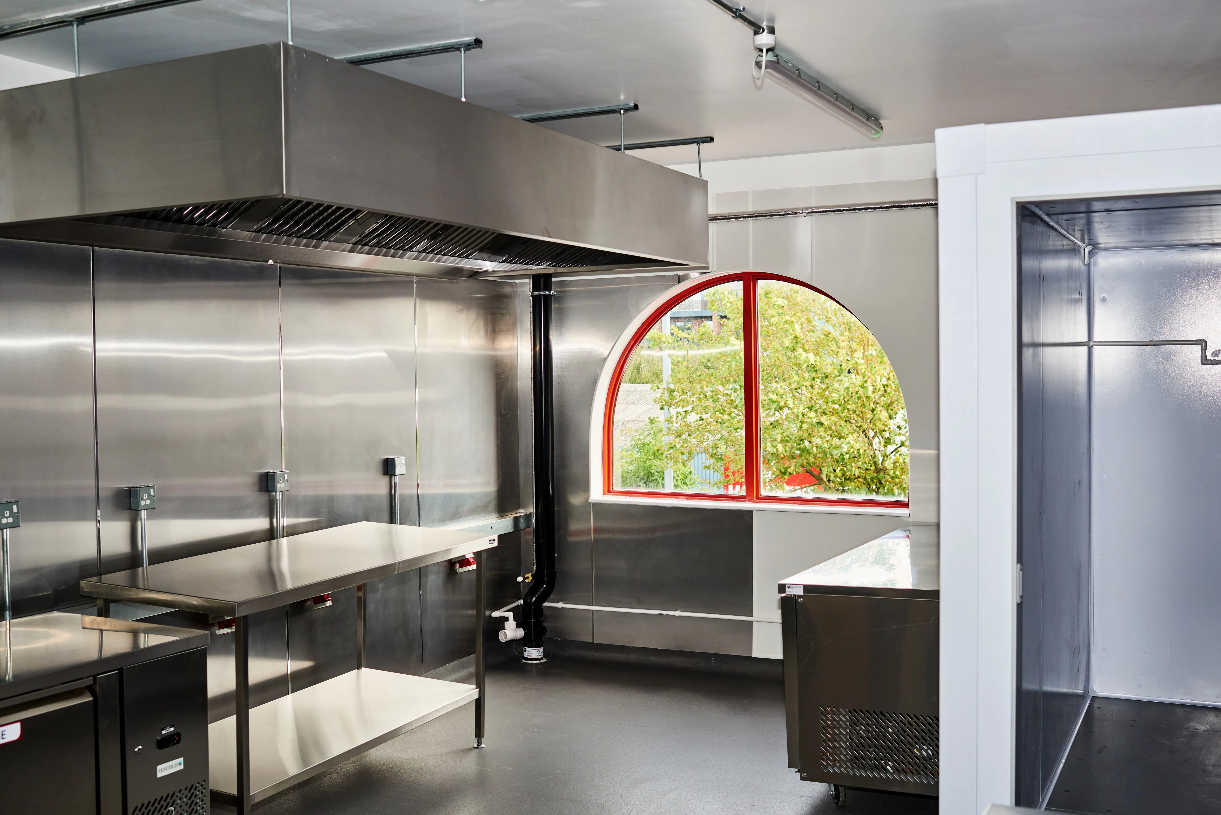 Small commercial kitchen with window overlooking greenery